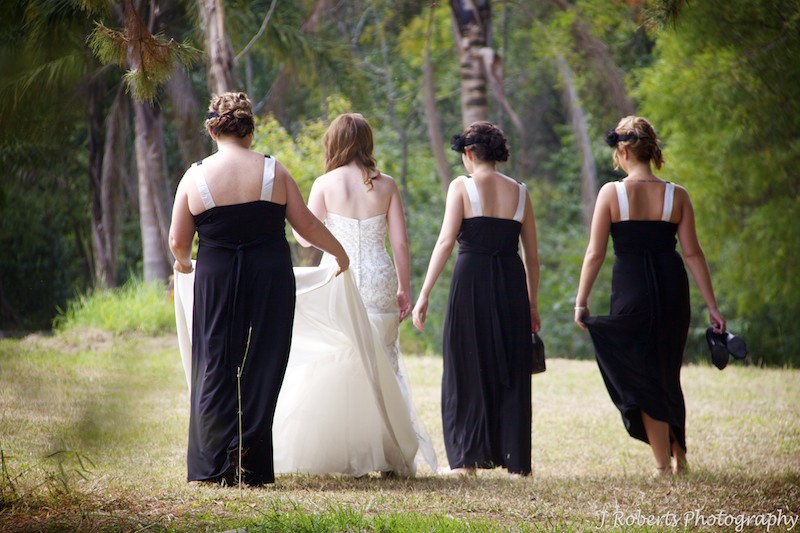 Bride walking with bridesmaids in bush setting - wedding photography sydney